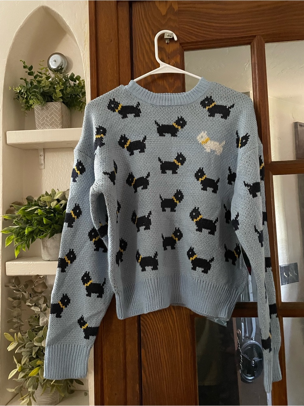 Stranger Things Light Blue Crewneck Sweater with Black Dog Motif